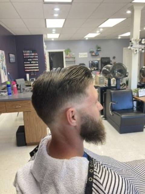 Sharp fade with a full beard, profile view