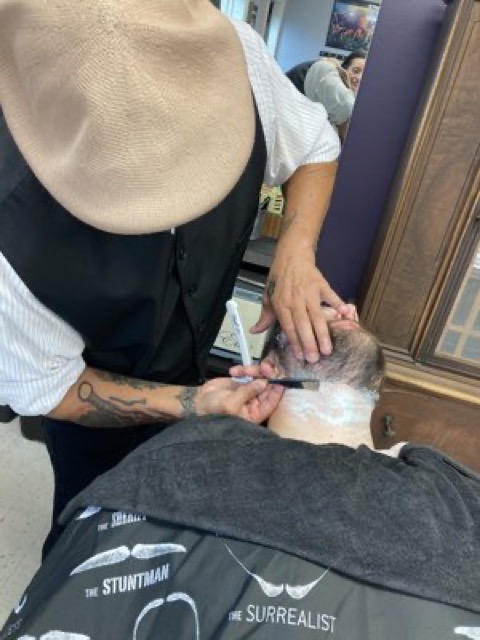 Straight razor line-up in progress, back of client's head